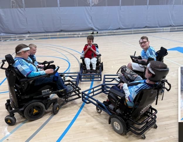 Colorado Rolling Rapids power soccer team huddling before a game